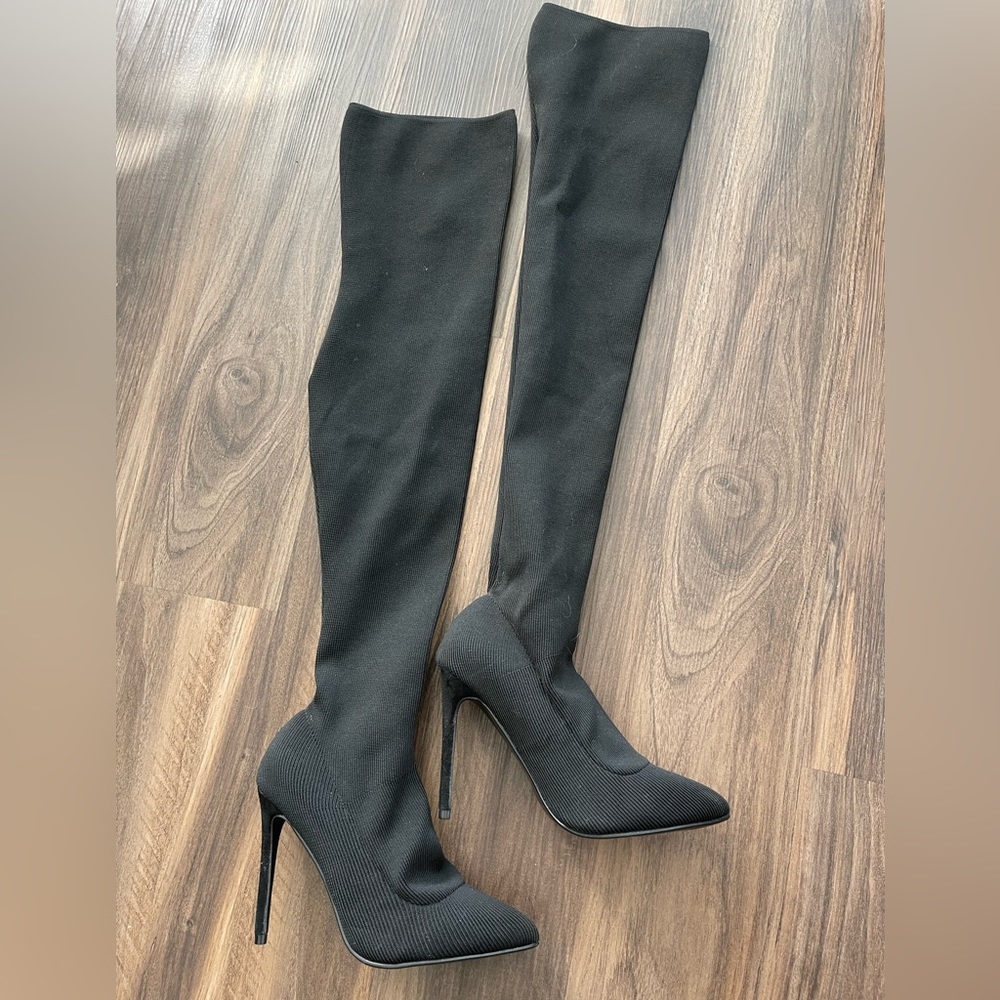 Black over the knee boots with stretchy material.